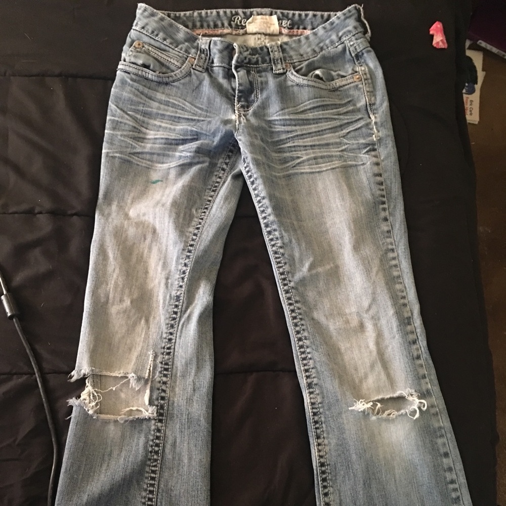 Two jeans an a blue shirt jeans both are designer